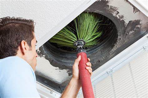 A Professional Cleaning an Air Duct