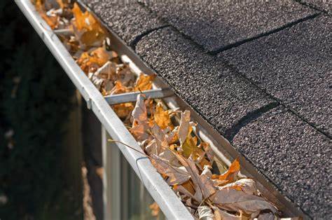 Rain gutter full of leaves needing cleaned or gutter guard istalled