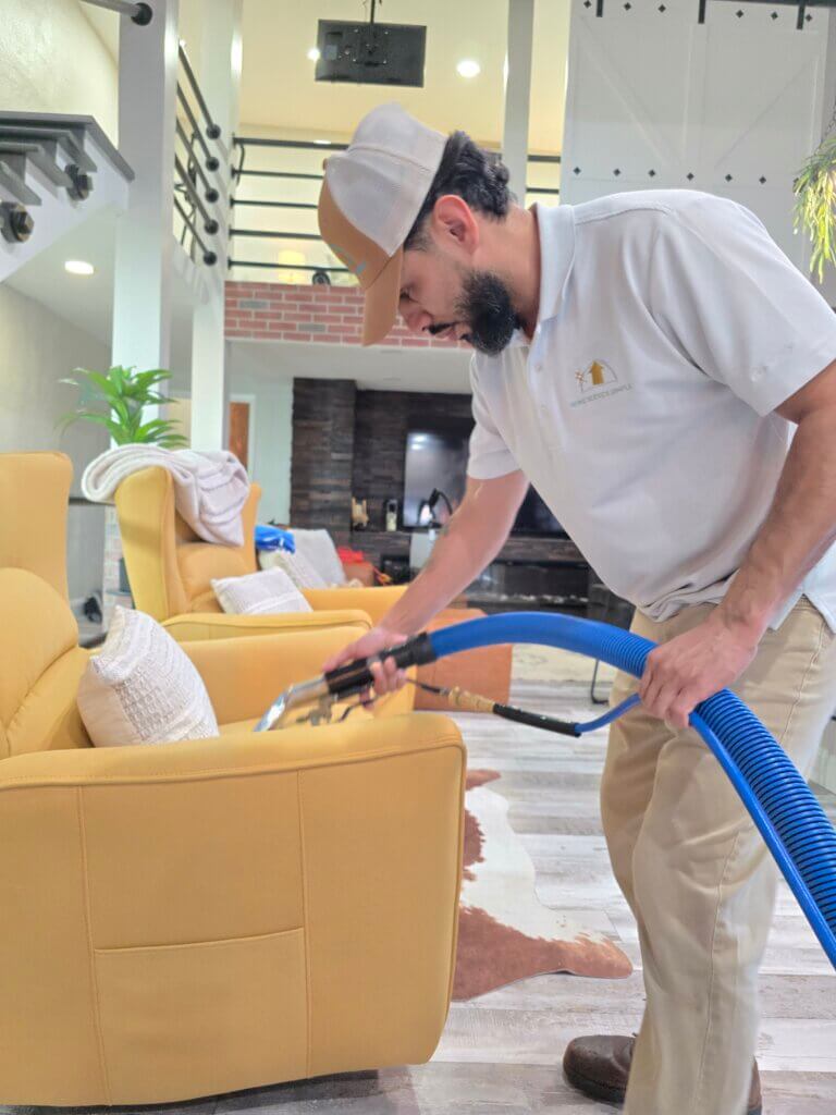 Carpet cleaning technician performing hot water extraction in a Wichita KS home