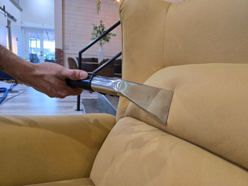 Carpet cleaning technician performing hot water extraction in a Wichita KS home
