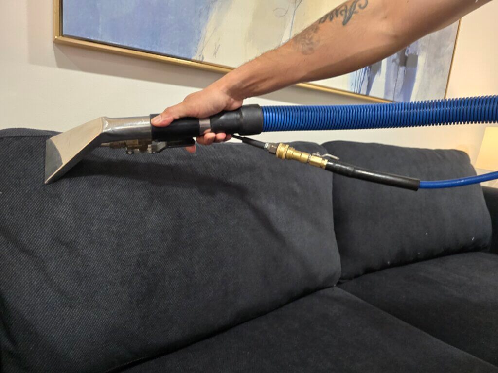 Carpet cleaning technician performing hot water extraction in a Wichita KS home